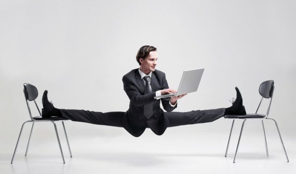 Business man demonstrating flexibility in process while working on laptop software solution
